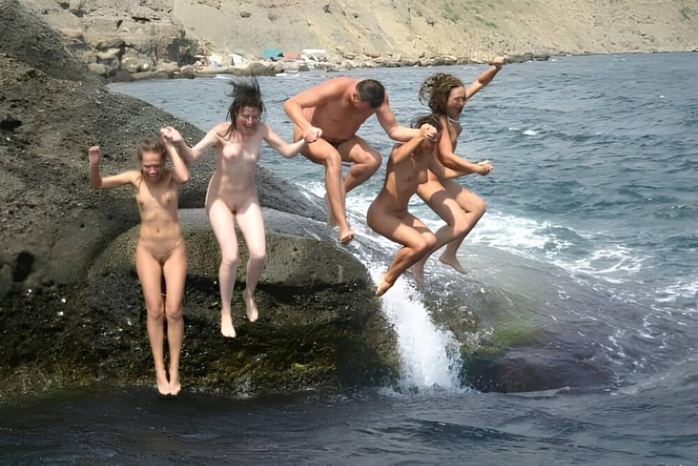 Mens and girls nudists on a beach - Harmony and balance are important in this nudist culture