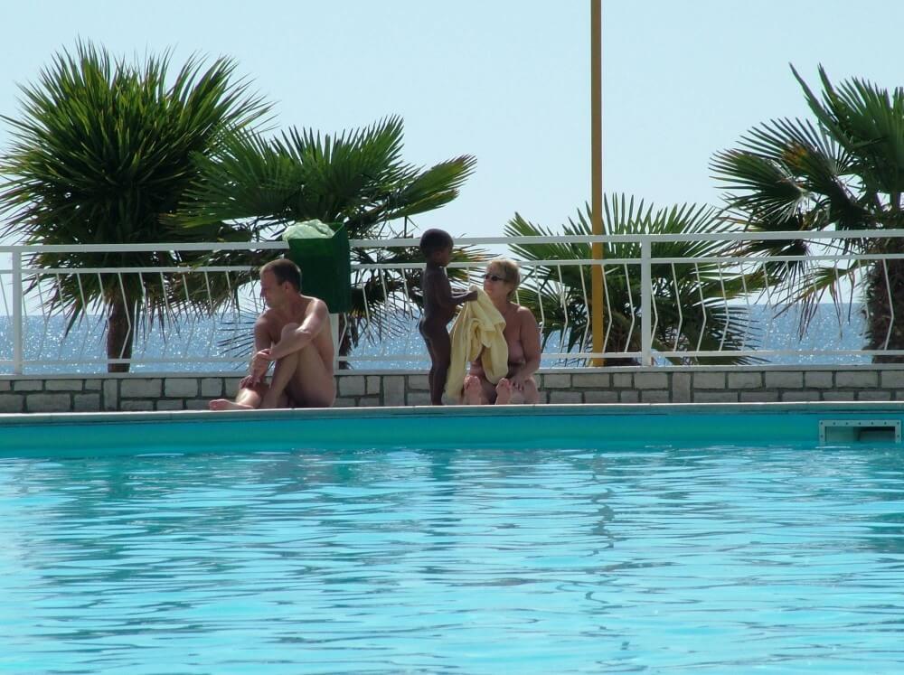 Photo of naturists in an outdoor pool - Simplicity is the key to nudism
