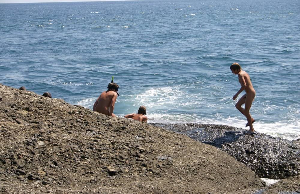 Leaning Against Hit Rocks pics - Spiritual and physical harmony are essential in nudist culture